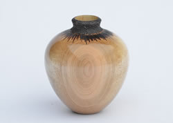Maple hollow form with pyrography at the neck turned by Dennis Curtis.